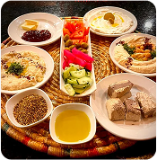 Grilled meats and vegetables on wooden board